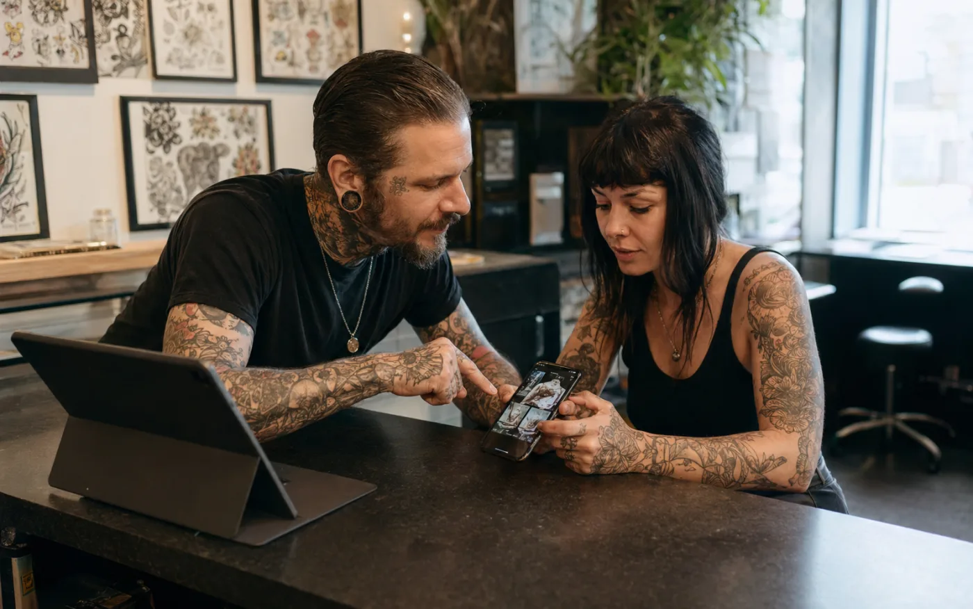 A client viewing an artist page and consultation entry on a phone