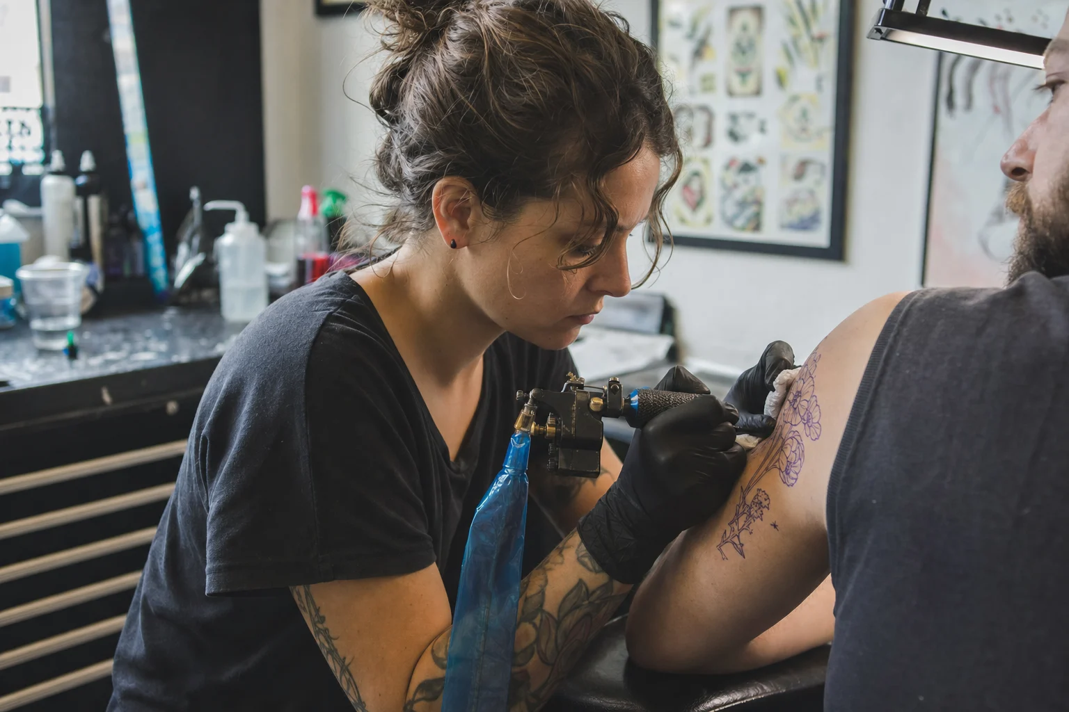 Tattoo artist working with gloves in a real neighborhood studio